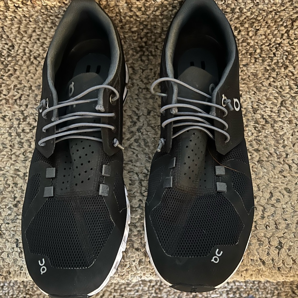 On Cloud running sneakers size 10.5. Black with white sole.